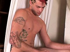 A gay dude is whipping out his cock and play with himself