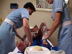 See two naughty nurses washing a beefy guy's body. They definitely take their time to do their job well and her certainly appreciates it.
