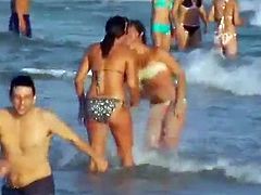 Check this out! Cutie takes her bikini off at the beach, two ladies touch each other in the ocean, and horny blondes lick each other's pussy inside a car.