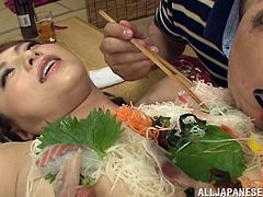 That smell of fish isn't vagina! It's actually sushi and sashimi that is covering this sexy lady. The men enjoy the tuna, salmon and daikon, before using a vibrator on this dirty slut and making her cum.