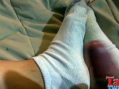 Angel is a twink with a foot fetish. He jerks off, keeping his feet close. He takes his white socks off at some point so that he can dump his load on his bare feet.