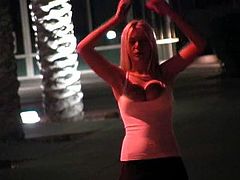 A beautiful blonde girl walks in the street at night. She pulls down a t-shirt and shows her boobies. In addition Alison shows her nude body against the background of the city lights.