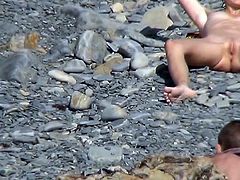 Nudist chick is getting naked on the beach