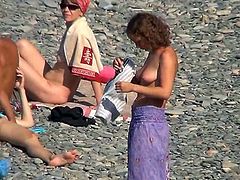 Horny voyeur must feel amazing watching such beauties exposing their nude forms at the beach