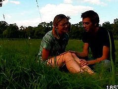 Golden-Haired touching her knees for sitting on the grass