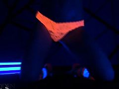 Blonde Madden wears a pair of orange panties and knee-long socks. She puts lotion on her nipples and turns on the black light. She teases with her sexy body.