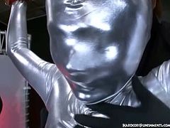 She got some punishment for not being obedient to her masters and got wrapped in a full silver bodysuit and got tied up toying her privates with the magic wand.