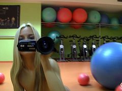 Sabrina is all alone by herself in the gym and she is ready to have some fun. She bounces up and down on the exercise balls and this makes her so happy. She films her self as she strokes her pink stra on in the mirror.