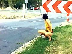 Take a look at this vintage video where this horny brunette pulls up her skirt in public and squats down to take a piss.