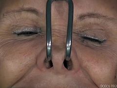 This slave is in such pain. She has hooks in her nose that pull on her nostrils. The masters puts hooks in her mouth so she has to submissively show her teeth. She has a thick metal collar around her neck and she is pounded with an electric fuck machine as she is confined in a torture chair. She has red scars from the beatings.
