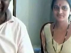 It looks like this Indian couple has their webcam on. At some point, she unbuttons her shirt and shows off her tits. Then, she dresses back on. They are exhibitionists.