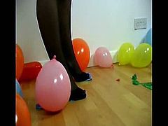 Watch as this busty slut in stockings and heels bursts these balloons