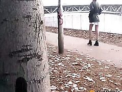 The girl sitting on a bench lifts her skirt