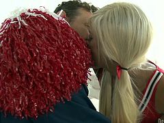 This sexy blonde cheerleader has something hiding underneath her skirt. She has a huge pecker hiding under there. She is kissing the quarter back and pretty soon they are horny beyond belief. She sucks and tugs him off.