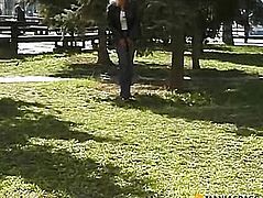Blonde squatting to pee on the grass