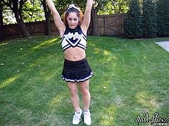 A cute cheerleader flashes her tits while in her uniform