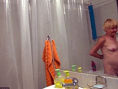 Ugly frightening blonde oldie takes a shower and teases her mature cunt