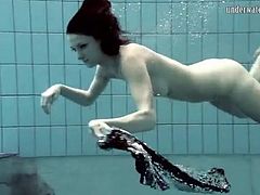 Skinny girl looks sexy as she goes swimming nude
