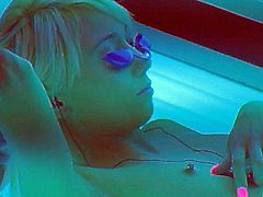 Skinny short haired blonde girl Moretta Cox removes her bra and shows her tiny tits in solarium. She loves tanning naked. Her small hard nipples are totally exposed in this voyeur video,