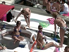 Bikini-clad brunette with a great body flashing her tits and pussy in public