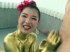 Check out this Asian girl completely painted gold. She dazzles us with her body and cute smile. The hottie winks at the camera and timidly kneels in front of her man's penis to suck him off. The gold queen works the shaft, while using her lips on the head.