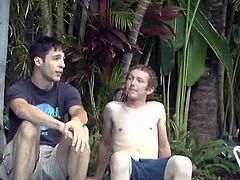Cute gay guy with short curly hair enjoying a cock suck next to his swimming pool