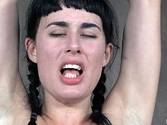 Weighted nipple clamps give her pain, this bondaged brunette cannot stop feeling uncomfortable and yet so incredibly horny. After her big tits get tortured, her master decides it's time to make her know what happens, when a candle is lit in his dungeon. She looks lost and shocked, but also so horny