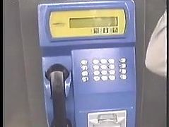 Girl peeing in telephone booth