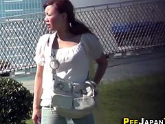 Asian babe pees outdoors