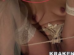 Pretty girl dressed as a bride tied in a BDSM scene