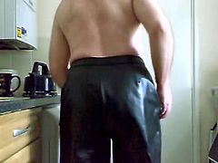 spanking in black rubber trousers