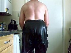 spanking in black rubber trousers