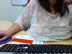 Webcam secretary flashes her heavy hangers in the office