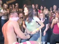 Natural boobed brunette on her knees giving one of the male dancers a deepthroat blowjob, while behind her is another brunette with a tattoo and a very nice round bubble butt, getting fucked hard from behind for a creampie.
