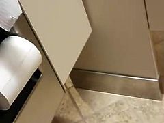 Spying brunette over toilet stall