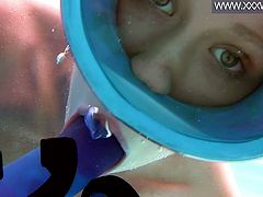Seductive diver Minnie Manga sucks a suction cup dildo under the water