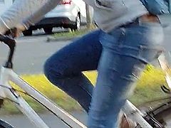 Candid ass in jeans - young girl riding bike