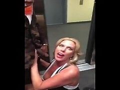 Blonde MILF sucks black cock in an elevator