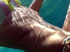 Heidi Klum swimming underwater in a bikini