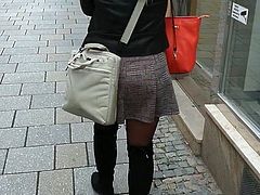 Black pantyhose and overknee boots on the street