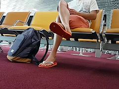 Boy put on flip flops and anklet in airport