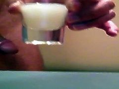 Filling a shotglass with cum