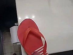 Friend having fun with his moms Maria flip flops at home