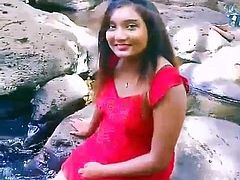 Sexy girl playing water in a river