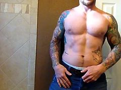 straight muscle tatted man pumps a nut