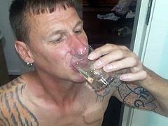 Man drinking piss of his girlfriend from a glass
