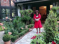 SIndy in red cocktail dress and jacket outside