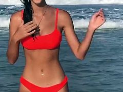 Hot girl in orange bikini on the beach